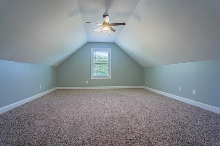 Slanted ceilings frame a versatile bonus space finished with soft wall-to-wall carpeting.