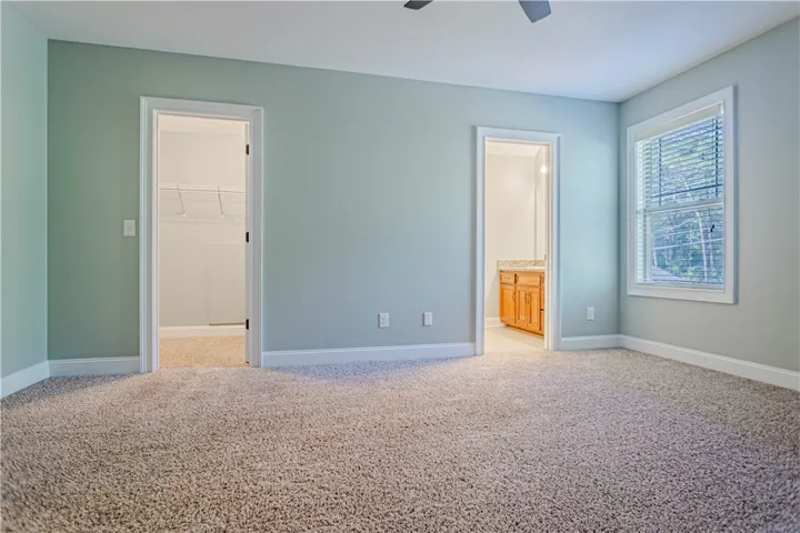 A spacious layout connects the primary suite directly to a private bath and walk-in closet.