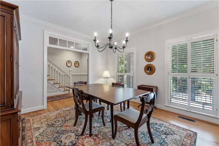 Rich hardwood floors and elegant crown molding define this formal dining space.