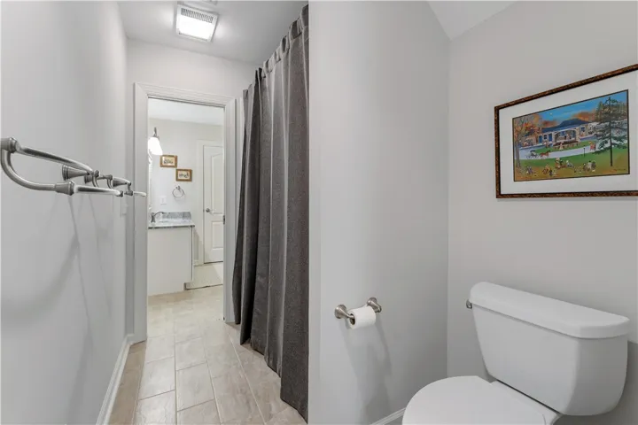 Tiled flooring guides the way through this functional bathroom layout.