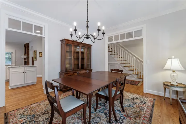 Elegant crown molding complements classic wood flooring in this central dining area.