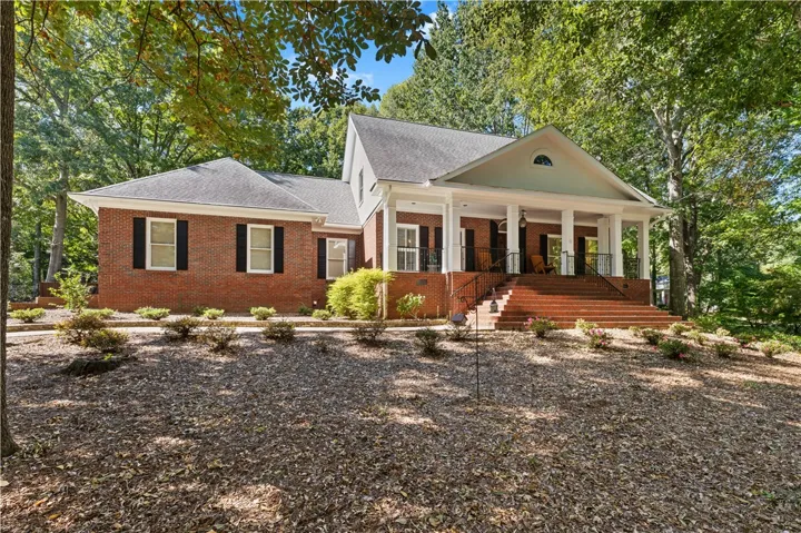 Stately brick architecture defines this classic home nestled among mature trees.