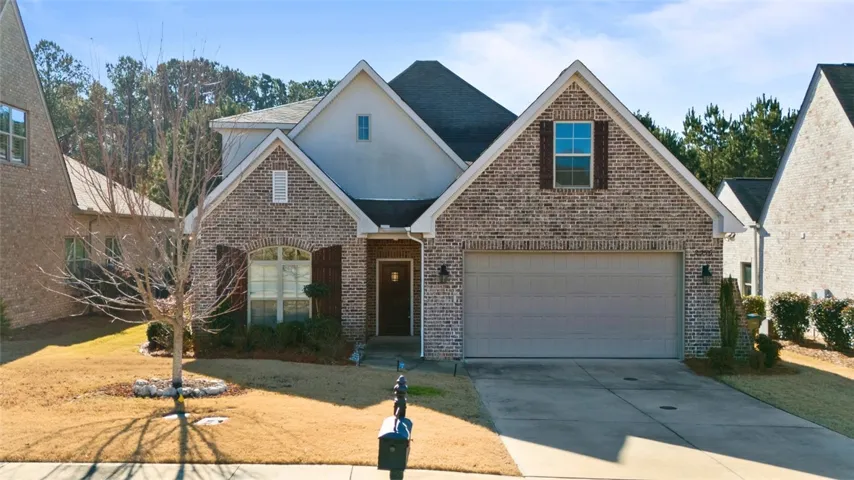 Multi-textured brick exterior and a neat concrete driveway present striking curb appeal.