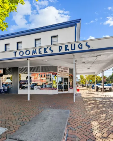 Historic architecture featuring a classic storefront design surrounded by elegant brick-paved walkways.