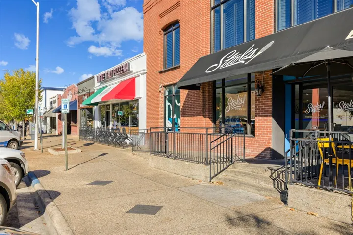 Classic brick architecture frames a vibrant commercial streetscape steps from local dining.