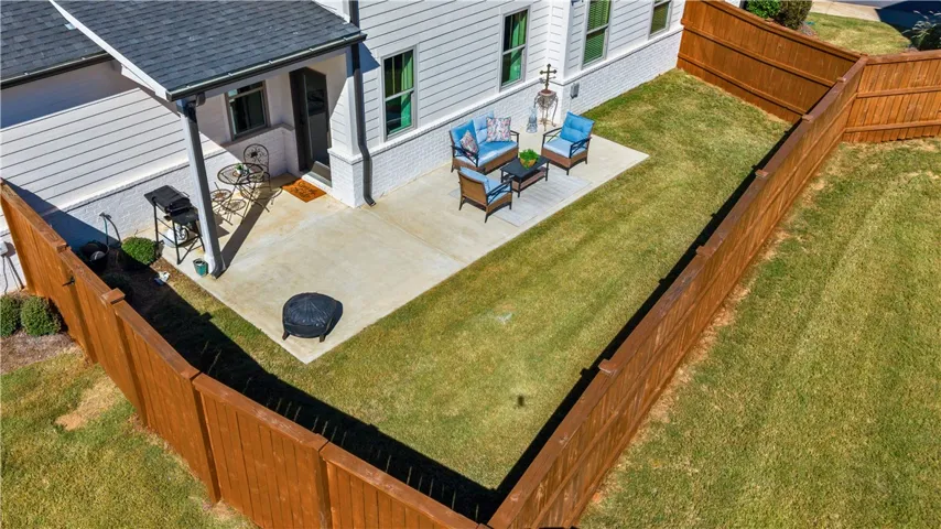 Just right amount of yard space!  Notice the beautiful, wooden privacy fence (recently stained).