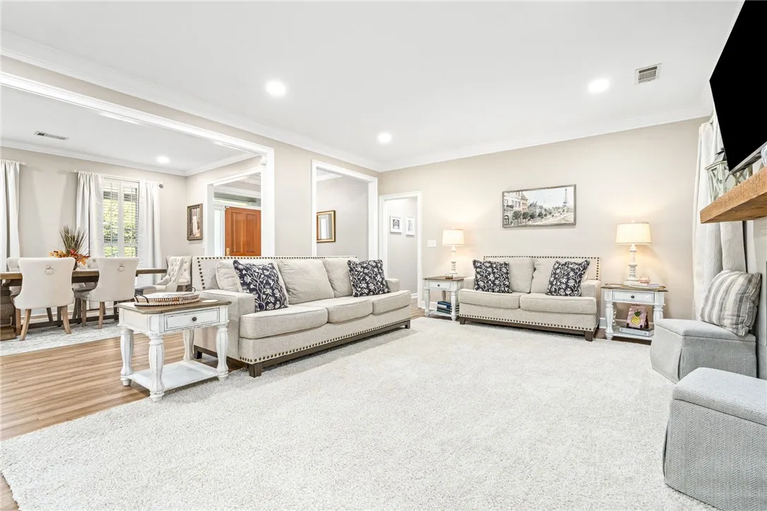 Gleaming hardwood floors and classic crown molding accent this welcoming, open living space.