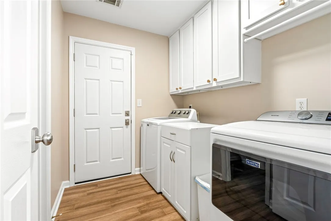 Functional workspace features built-in cabinetry, durable wood-look flooring, and a private exterior entrance.