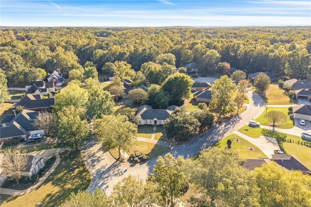 Lush woodland surrounds this quiet residential enclave showcasing mature trees and winding streets.