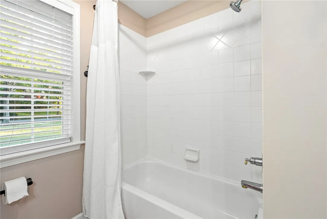 Crisp white wall tile surrounds the tub in this classic bathroom setting.