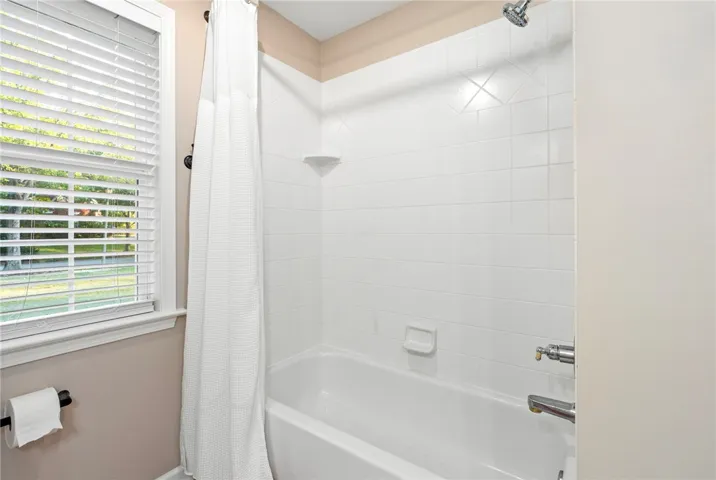 Crisp white wall tile surrounds the tub in this classic bathroom setting.