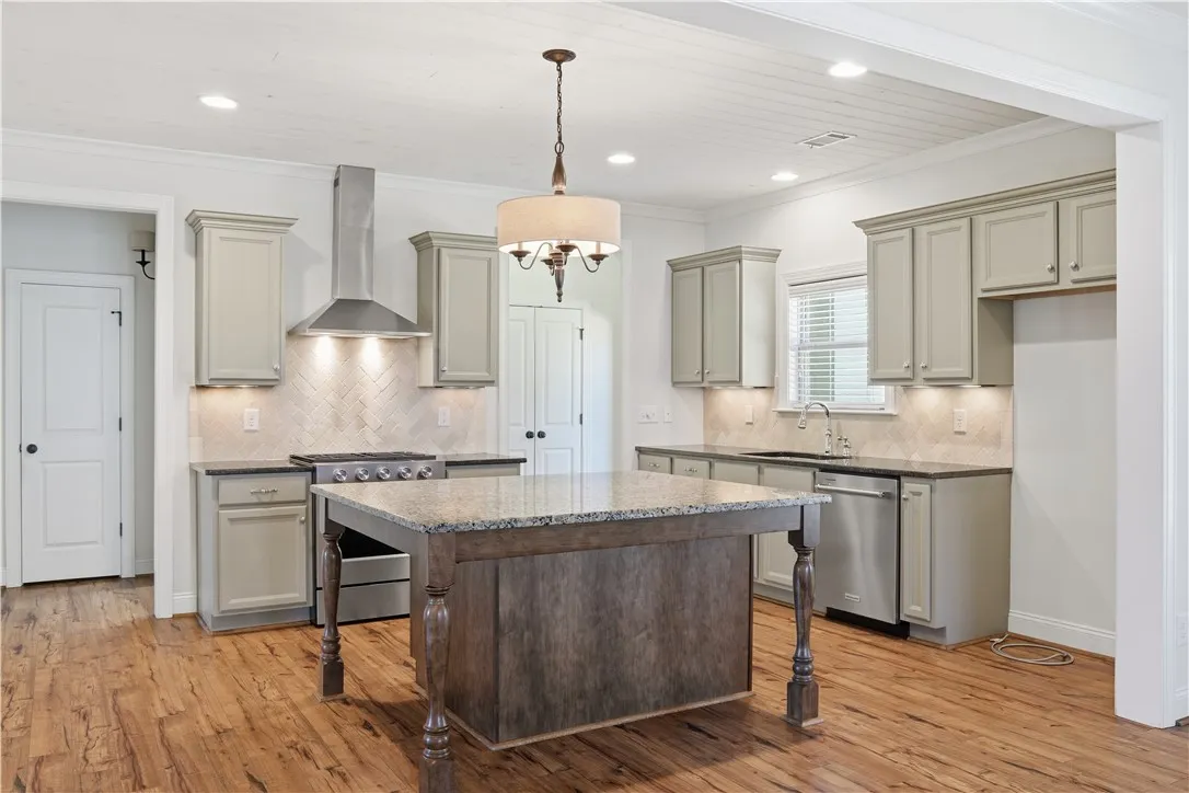 Tongue and groove ceiling, a hint of green in the cabinetry and warm tones, make the kitchen a shA tongue-and-groove ceiling paired with subtle green cabinetry and warm accents creates a kitchen that feels effortlessly welcoming.