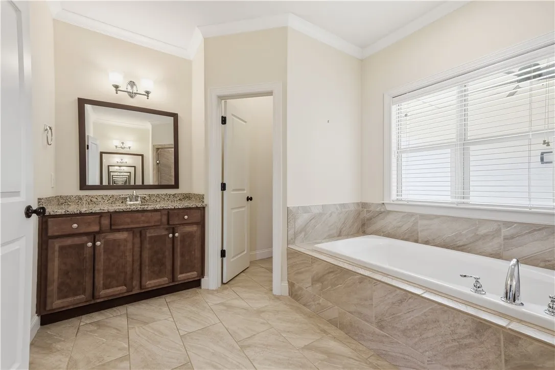 The breezeway-facing window invites natural light into the room while preserving a sense of privacy.