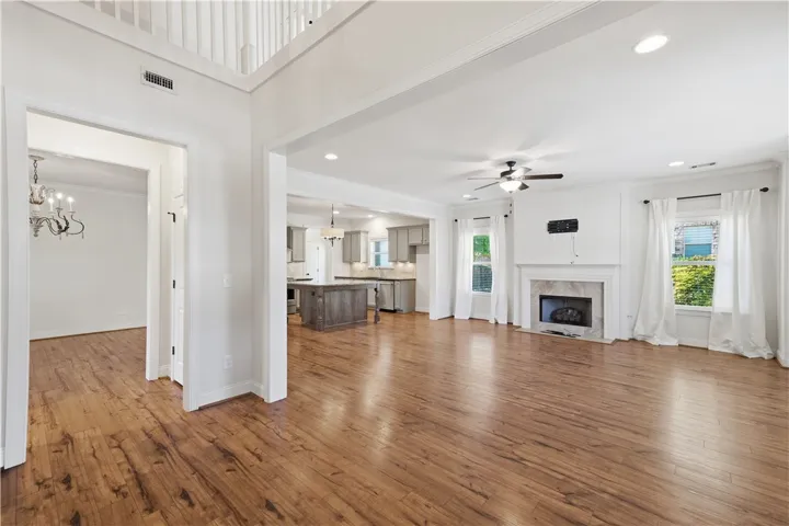 Rich wood floors flow seamlessly from the entry through the open living areas.