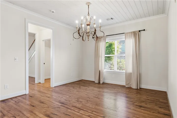 The dining room accommodates a large table and additional furniture.