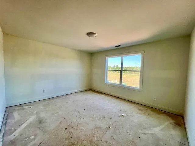 Natural light pours through a large window overlooking the open fields beyond.