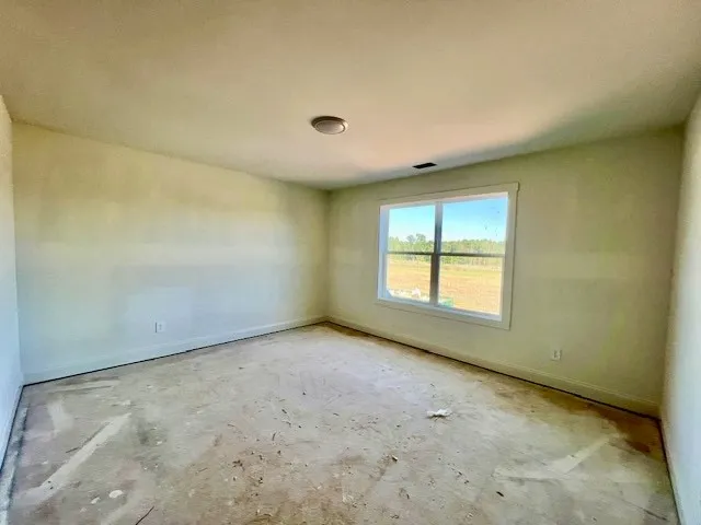 Natural light streams through a wide window framing peaceful pastoral views.