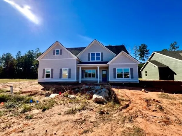 Symmetrical gables and decorative shutters enhance the exterior architecture of this newly constructed home.