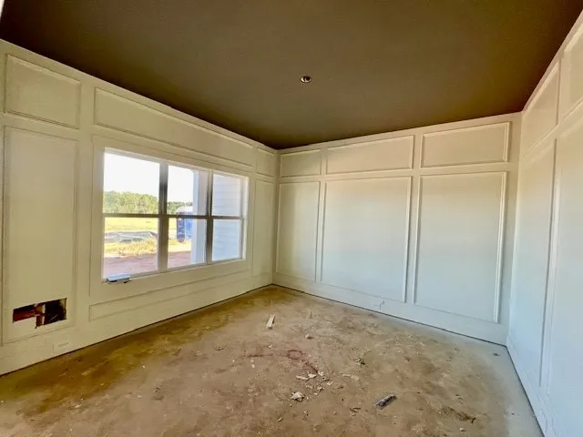Classic millwork and wainscoting frame this space under a high ceiling.
