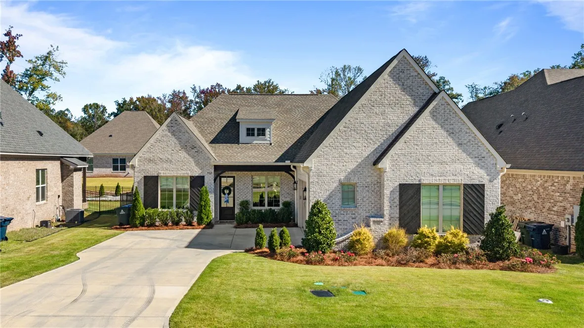Gable rooflines and classic brickwork define this inviting exterior.