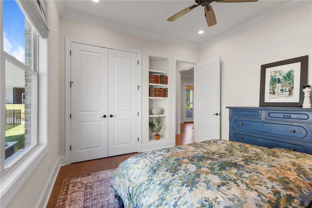 Rich hardwood flooring complements the neat crown molding and practical built-in shelving.