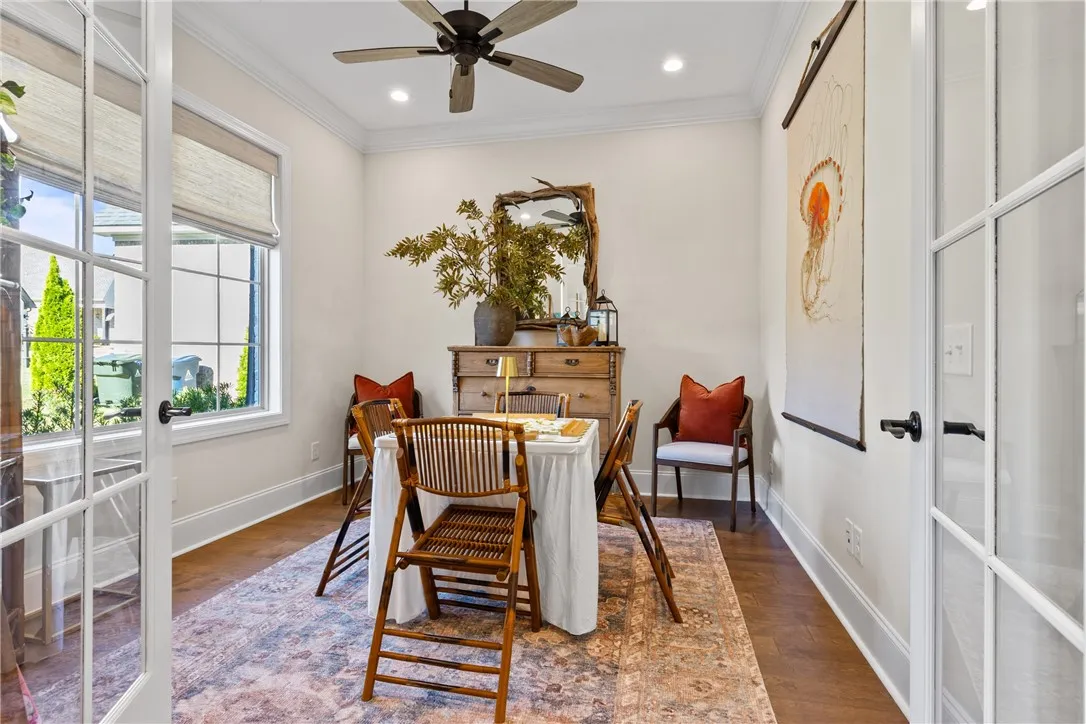 Gleaming hardwood floors and classic crown molding define this versatile dining space.