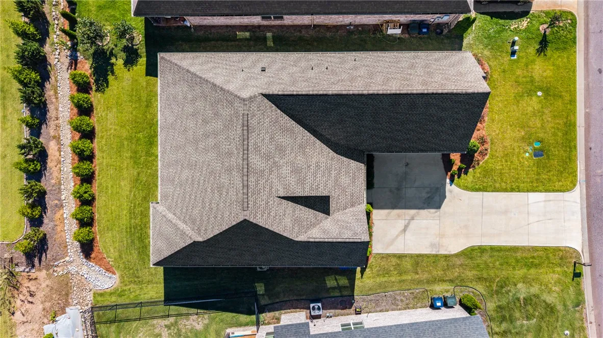 A top-down aerial view highlights the clean architectural lines of the shingled roof.