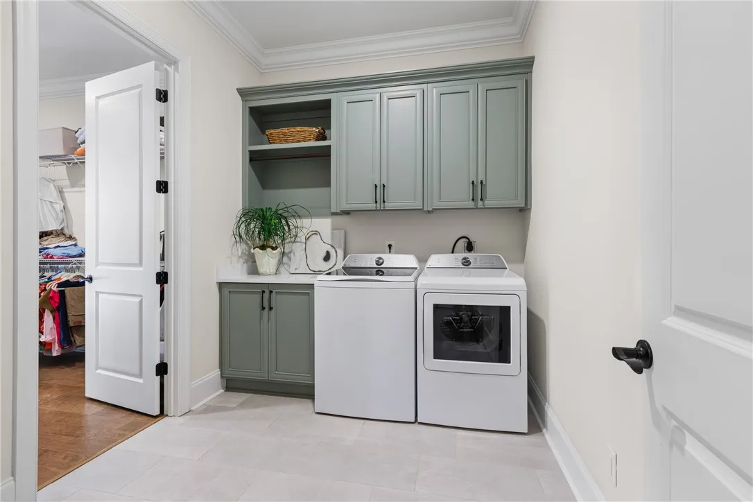 Elegant crown molding and custom cabinetry elevate this highly functional laundry space.