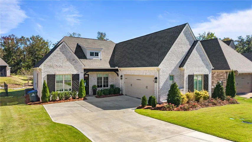 A classic brick exterior and a concrete driveway define this modern single-family home.