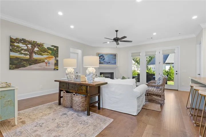 Rich hardwood flooring complements the open layout, offering easy transitions and crown molding details.