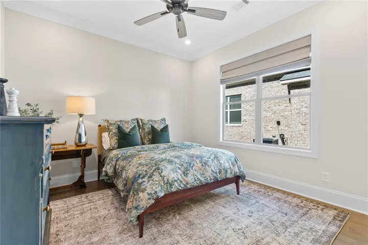 Gleaming hardwood floors and classic crown molding define this inviting bedroom space.