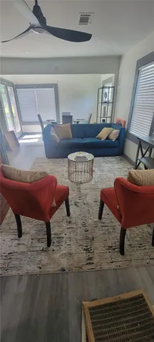 An open living layout links the gathering space directly to adjacent dining areas.