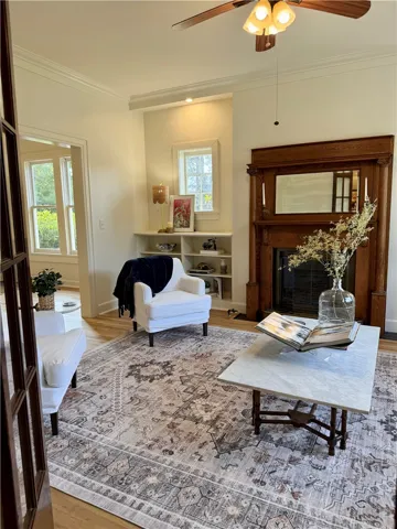 Large living space enhanced with a rich, ornate wood fireplace mantel with integrated mirror. Beautifully detailed millwork & recessed window alcoves with built-in shelving.