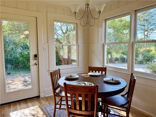 Sunlight streams through multiple windows into this cozy breakfast area enhanced with updated millwork charm