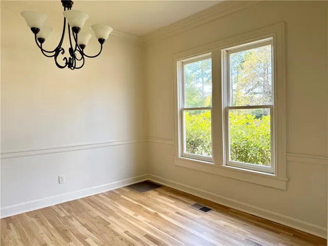 New white oak hardwood floors and classic crown molding are the perfect setting for warm sun & formal dining gatherings