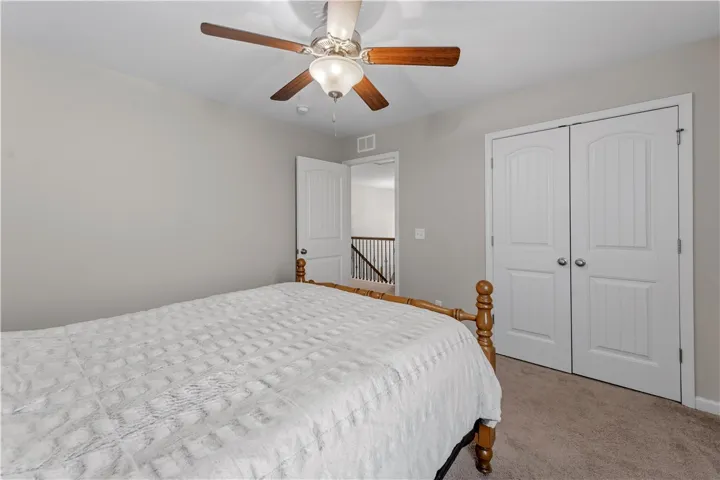 Soft carpeting underfoot defines this inviting bedroom space complete with clean lines and classic paneled doors.