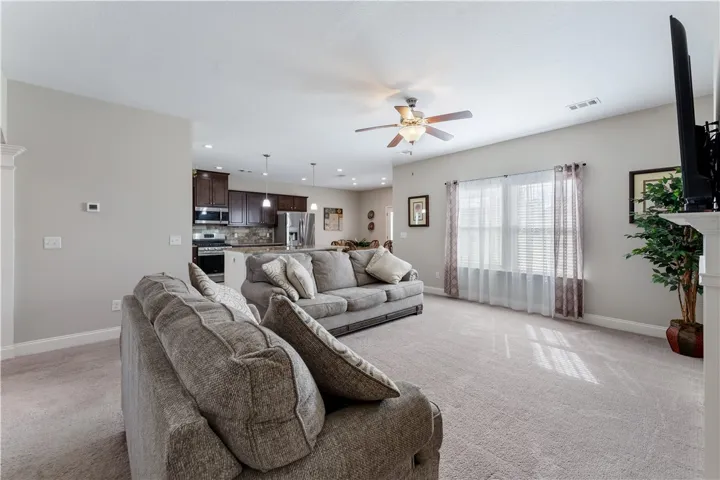 An open layout connects this comfortable living area directly with the adjacent kitchen space.