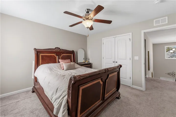 Soft wall tones complement plush carpeting in this comfortable upstairs bedroom retreat.