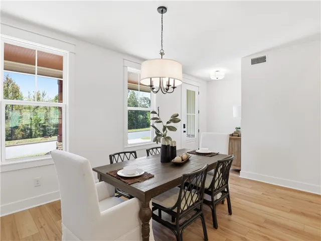 Gleaming wood floors and classic multi-pane windows anchor this welcoming dining space.