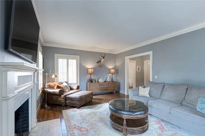 Rich hardwood flooring pairs with classic crown molding in this inviting living space.