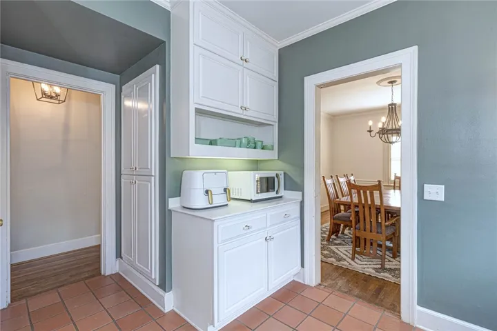 Built-in cabinetry and classic tile floors connect these inviting interior spaces seamlessly.