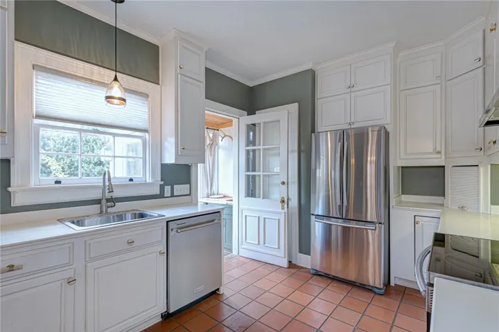 Timeless cabinetry and classic tiled flooring define this beautiful kitchen space.