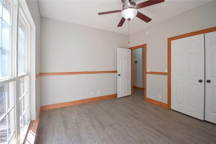 Warm wood trim accents the chair rails and baseboards of this versatile room.
