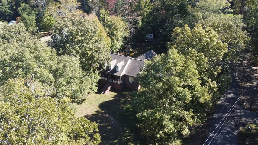 Thickly wooded grounds encircle this secluded home nestled in a clearing.