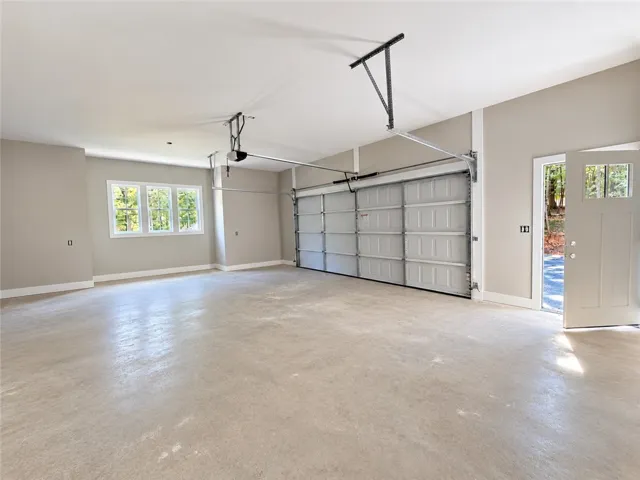 An oversized  two car garage provides substantial utility with a storage closet and direct outdoor access.