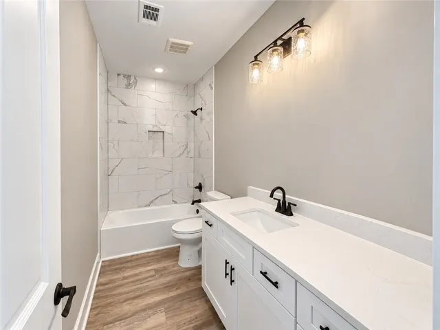 Shared bath- Tub/shower with surround tile to ceiling.