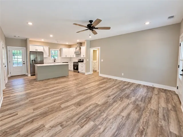 An open floor plan connects the main living space to a modern kitchen.