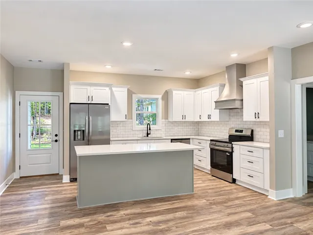 Gleaming quartz countertops and stainless appliances anchor this classic kitchen
workspace.