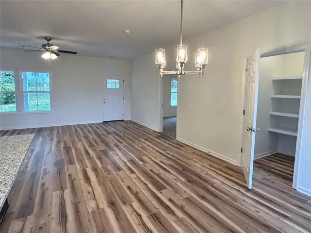 Rich wood floors extend throughout this open living and dining area with clean finishes.
