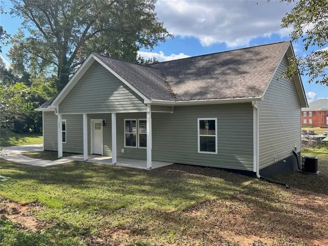 A welcoming front porch enhances the simple, classic architecture of this vinyl-sided home.